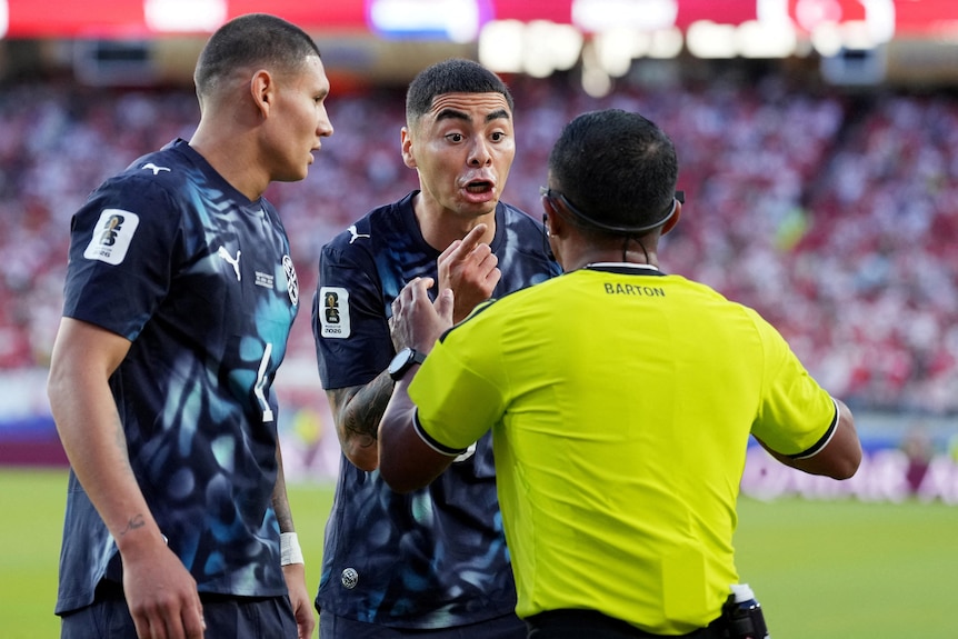Miguel Almiron argues in the face of the referee.
