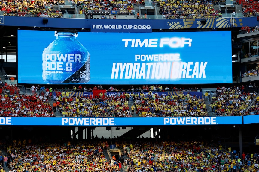 The big screen in a stadium reads "Time for a Powerade Hydration Break"